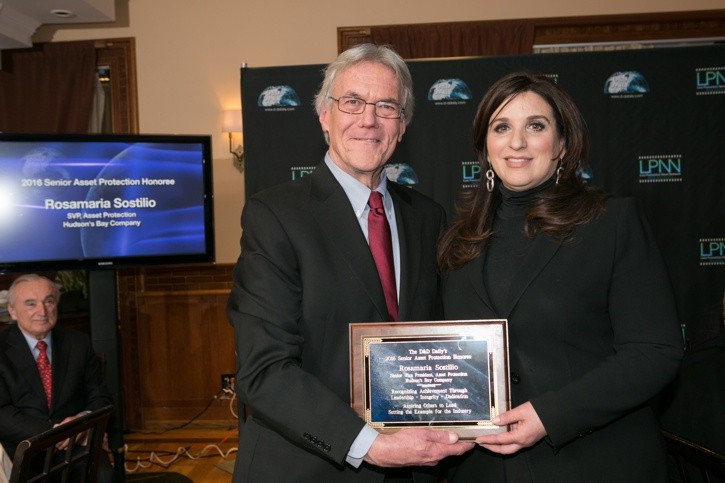 Gus Downing presenting the plaque to Rosamaria Sostilio, this years' Honoree